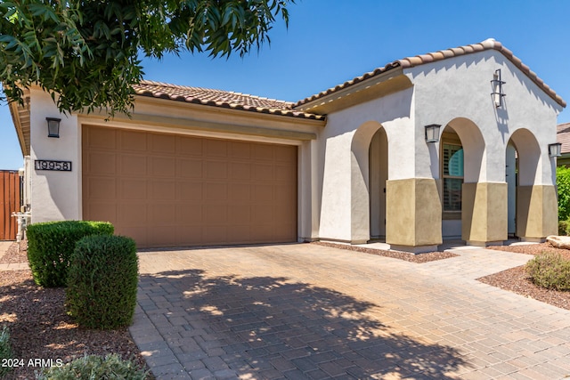 mediterranean / spanish house with a garage