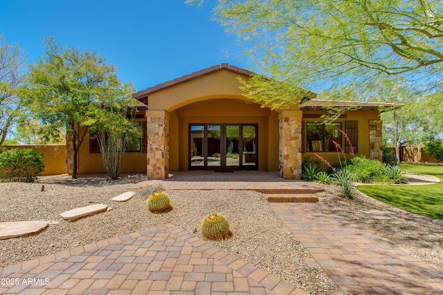 26156 N 88th Way, Scottsdale, AZ 85255 - view of exterior entry with stucco siding, stone siding, and french doors