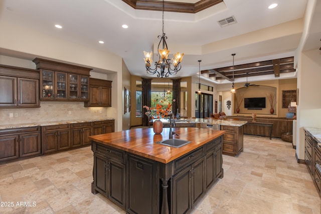 26156 N 88th Way, Scottsdale, AZ 85255 - kitchen with butcher block counters, a tray ceiling, a large island, open floor plan, and recessed lighting