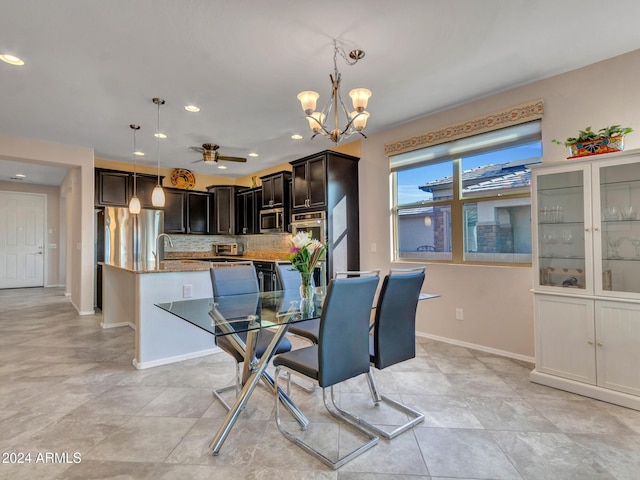 dining space featuring sink and an inviting chandelier