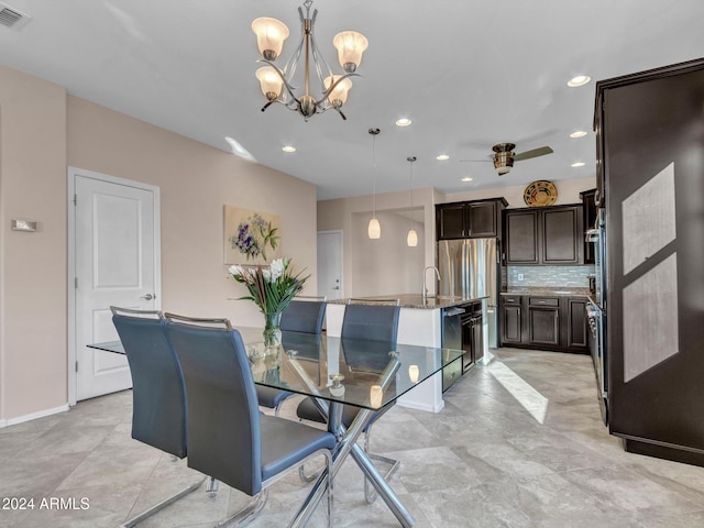 dining area with ceiling fan with notable chandelier and sink