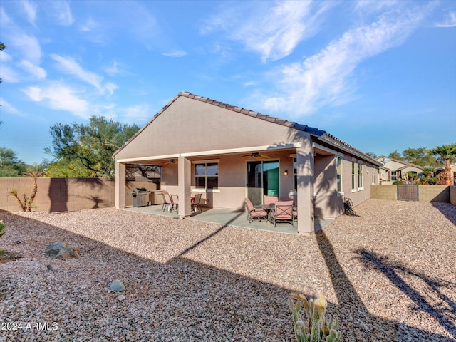 back of property featuring a patio area and ceiling fan