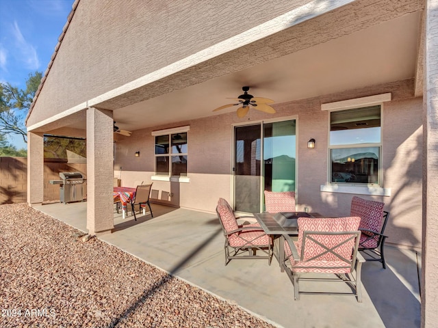 view of patio with grilling area, ceiling fan, and exterior kitchen