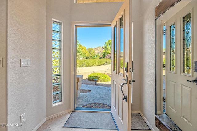 entrance foyer with light tile patterned floors