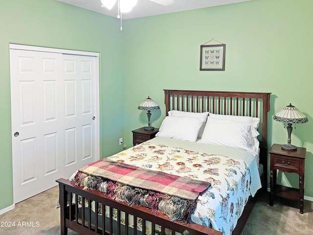 carpeted bedroom with ceiling fan and a closet