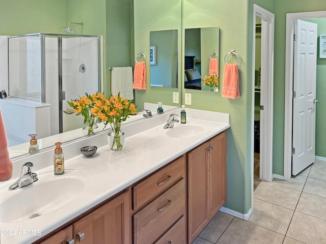 bathroom featuring tile patterned flooring, vanity, and an enclosed shower