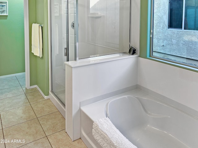 bathroom featuring tile patterned flooring and independent shower and bath