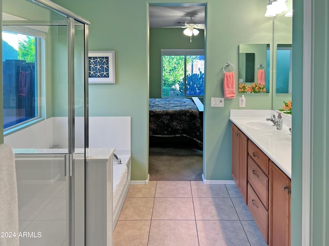 bathroom with tile patterned floors, ceiling fan, vanity, and a healthy amount of sunlight