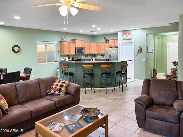 living room featuring light tile patterned floors and ceiling fan