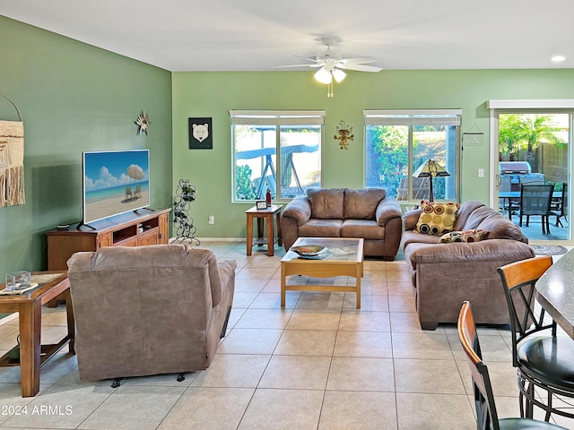 living room featuring light tile patterned floors and ceiling fan