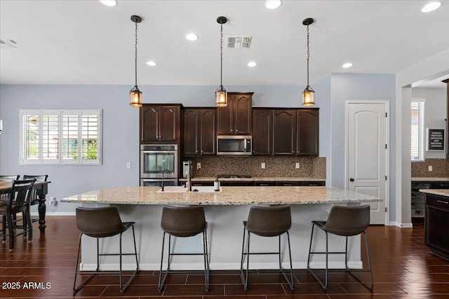 6788 S Jacqueline Way, Gilbert, AZ 85298 - kitchen featuring visible vents, backsplash, appliances with stainless steel finishes, and dark wood-style floors