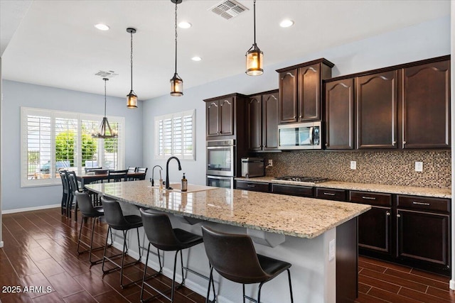 6788 S Jacqueline Way, Gilbert, AZ 85298 - kitchen with tasteful backsplash, visible vents, a sink, appliances with stainless steel finishes, and wood finish floors