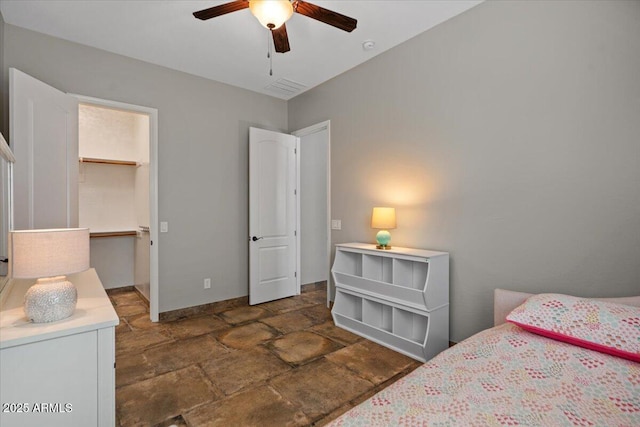 6788 S Jacqueline Way, Gilbert, AZ 85298 - bedroom featuring a closet, a spacious closet, ceiling fan, stone finish flooring, and baseboards
