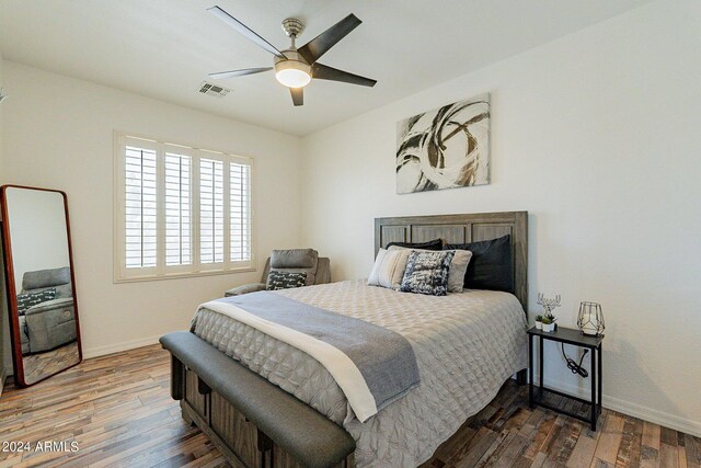 living room with wooden walls, ceiling fan with notable chandelier, and dark hardwood / wood-style flooring