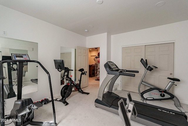 exercise room with carpet floors and baseboards