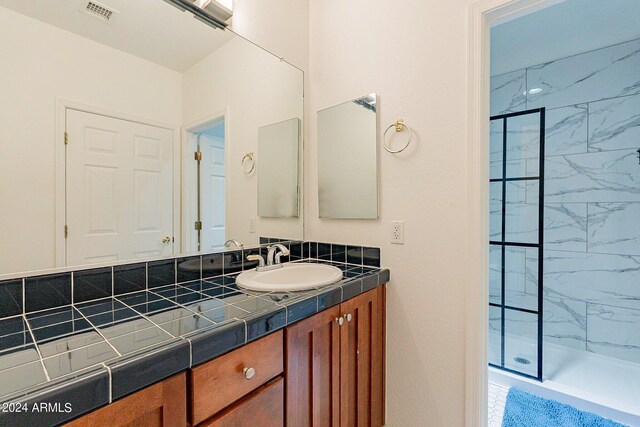 kitchen featuring pendant lighting, a wealth of natural light, dark wood-type flooring, and stainless steel dishwasher