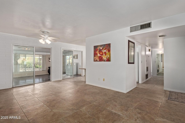 spare room featuring visible vents, baseboards, and ceiling fan