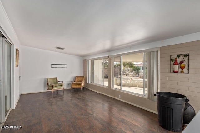sitting room with visible vents, baseboards, and wood finished floors