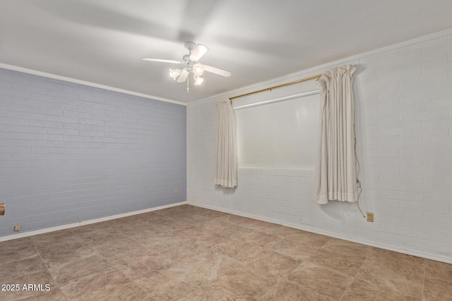 spare room with baseboards, brick wall, ornamental molding, ceiling fan, and tile patterned floors