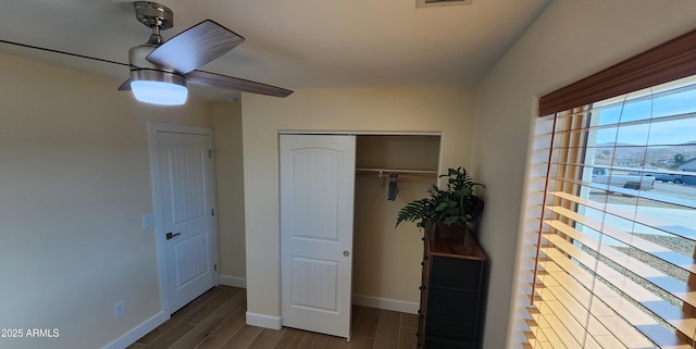 unfurnished bedroom featuring dark hardwood / wood-style floors and ceiling fan