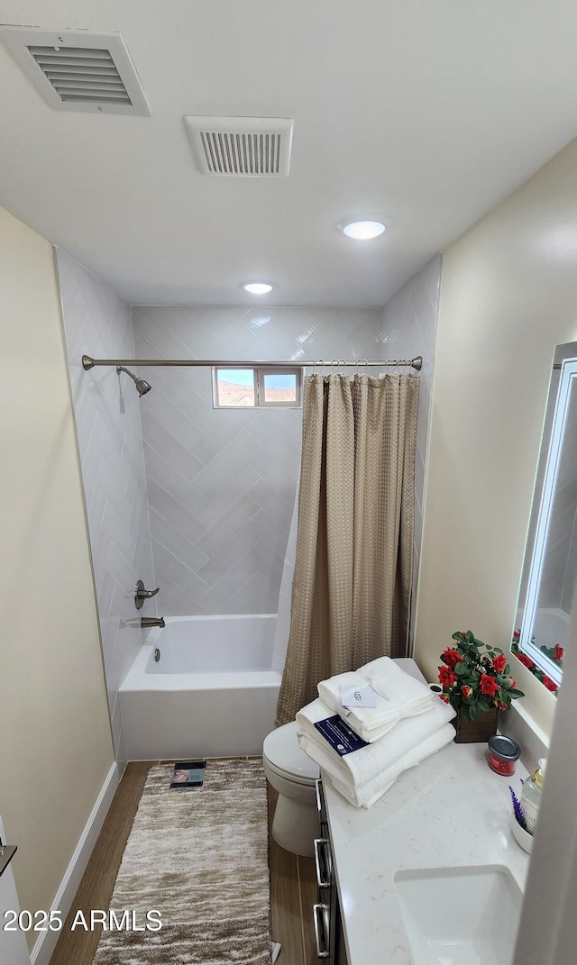 full bathroom with wood-type flooring, toilet, shower / tub combo with curtain, and vanity