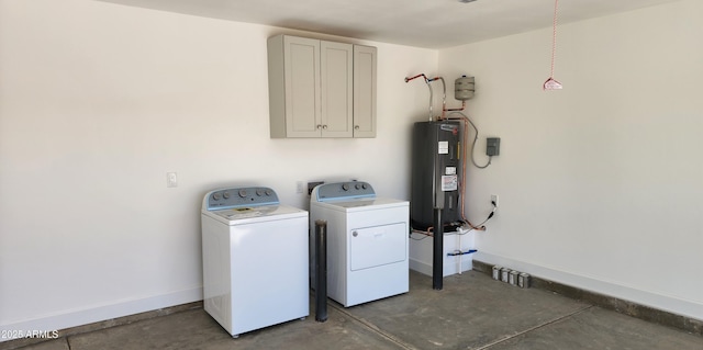 laundry area with washing machine and dryer, cabinets, and electric water heater