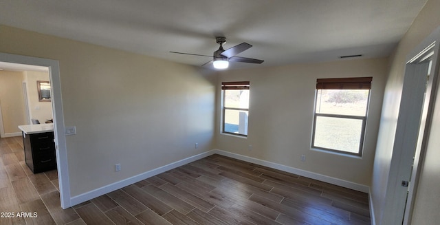 unfurnished bedroom with ceiling fan and dark hardwood / wood-style flooring