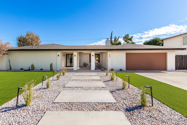 single story home featuring a garage and a front yard