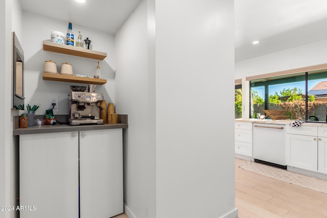 bar featuring dishwasher, light wood-type flooring, and white cabinets