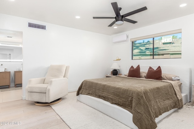 bedroom with hardwood / wood-style flooring, ceiling fan, and an AC wall unit