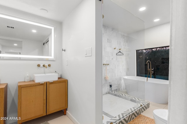 full bathroom with tile patterned floors, vanity, toilet, and plus walk in shower