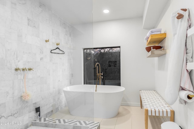 bathroom with tile patterned flooring and a washtub