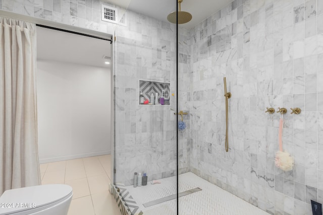 bathroom featuring a shower with curtain, tile patterned flooring, and toilet