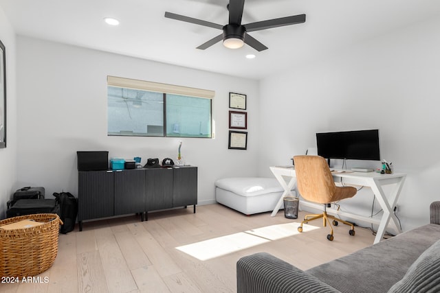 office with ceiling fan and light hardwood / wood-style flooring