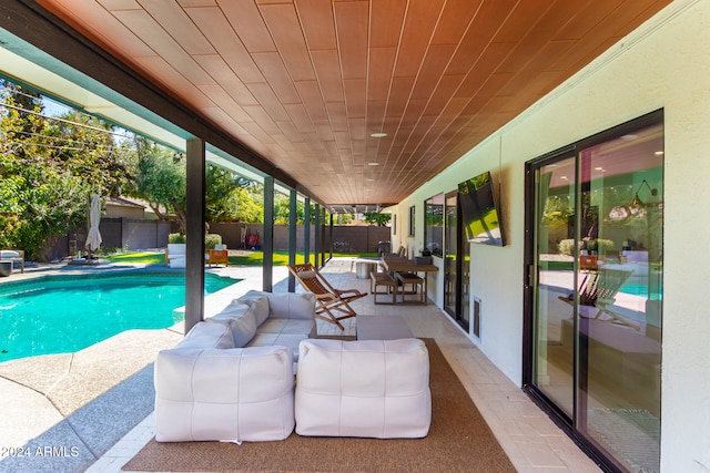 view of swimming pool with outdoor lounge area and a patio