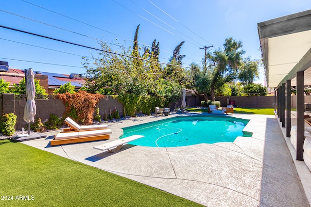 view of swimming pool with a diving board, a patio, and a yard