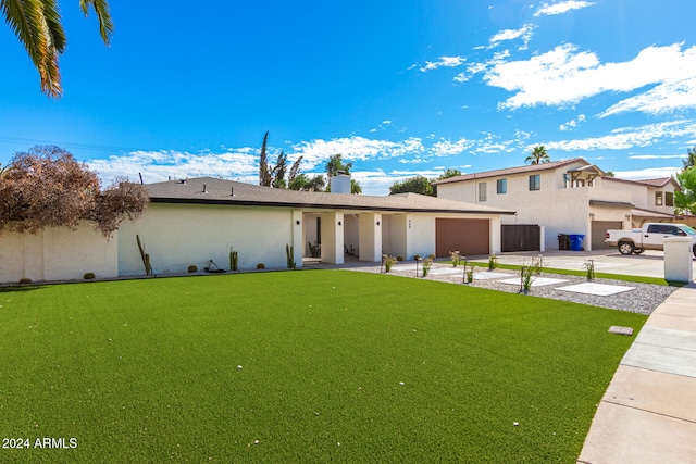 view of front facade featuring a garage and a front lawn