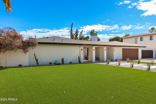 view of front of house with a garage and a front yard