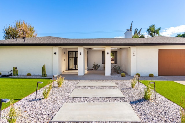 ranch-style house featuring a garage and a front yard