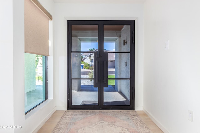 doorway to outside featuring light hardwood / wood-style flooring and french doors