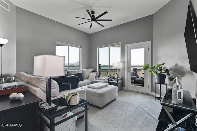 carpeted living room featuring ceiling fan