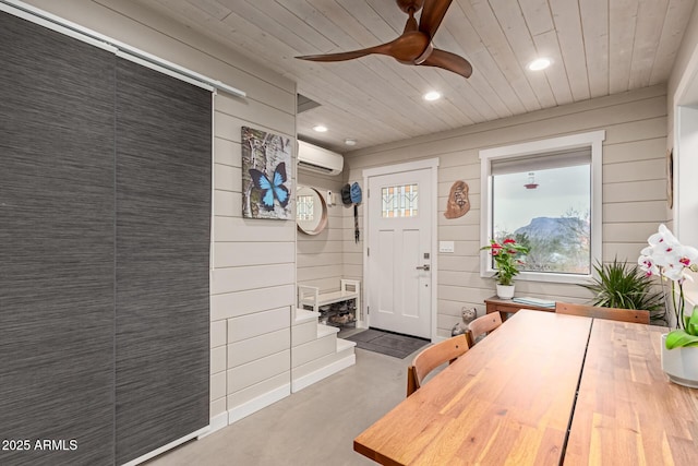 dining room featuring ceiling fan, wood ceiling, wooden walls, and a wall mounted AC