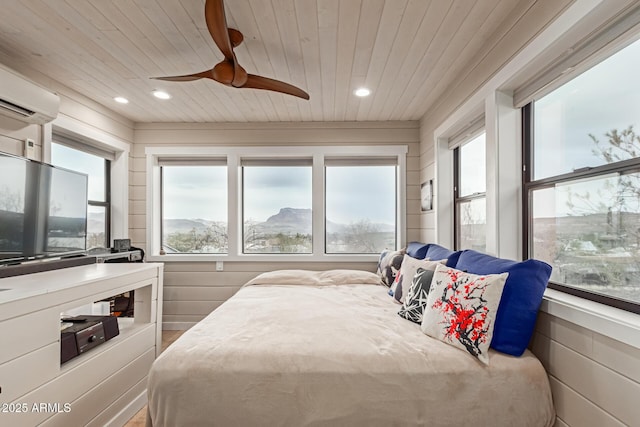 bedroom featuring ceiling fan, a mountain view, wooden ceiling, and an AC wall unit