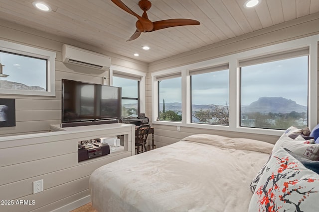 bedroom with ceiling fan, wooden walls, wood ceiling, and a wall unit AC