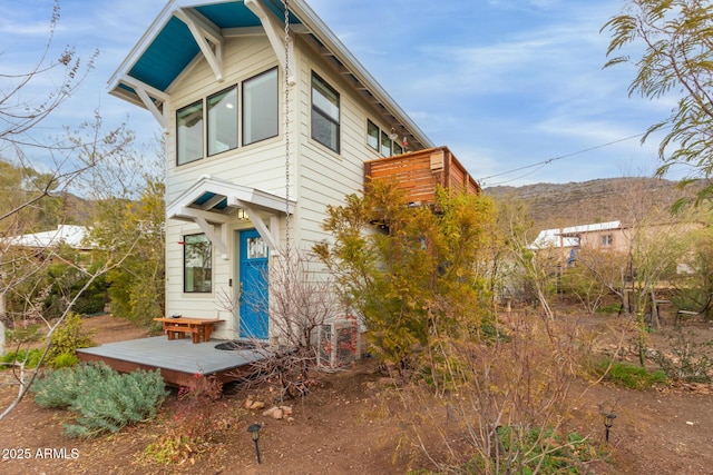 view of front of home with a deck with mountain view