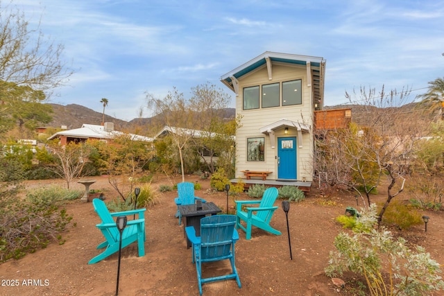 exterior space with a mountain view and a fire pit