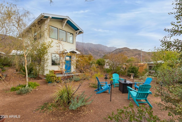 view of play area with a mountain view and a fire pit