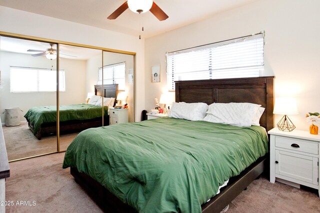 bedroom with light carpet, a closet, and a ceiling fan