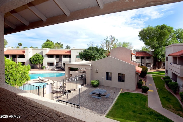 pool featuring a patio area, fence, and a residential view