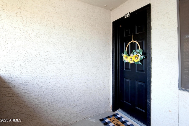 entrance to property with stucco siding